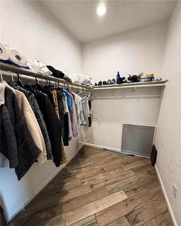 spacious closet featuring hardwood / wood-style flooring