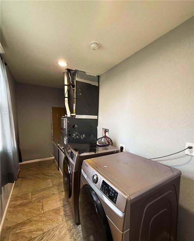 clothes washing area with washing machine and clothes dryer