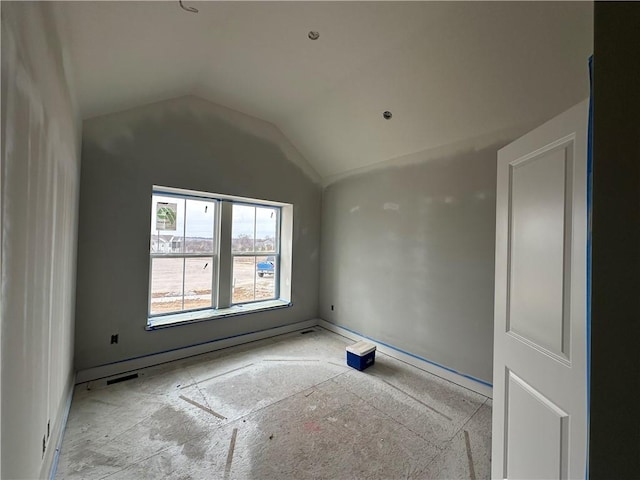 empty room with lofted ceiling