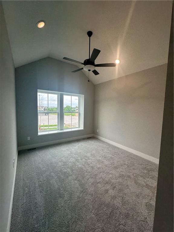 7050 NW Yulich Ct, Parkville, MO 64152 - empty room featuring baseboards, carpet flooring, a ceiling fan, and vaulted ceiling