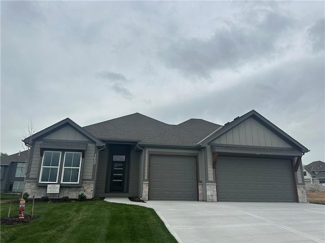 7050 NW Yulich Ct, Parkville, MO 64152 - view of front of house with a garage, board and batten siding, driveway, and stone siding