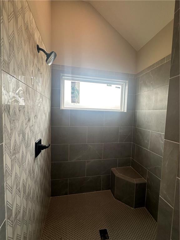 7050 NW Yulich Ct, Parkville, MO 64152 - full bath with vaulted ceiling and a tile shower