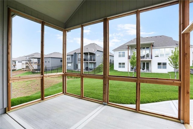 7050 NW Yulich Ct, Parkville, MO 64152 - unfurnished sunroom featuring a residential view, vaulted ceiling, and wood finished floors