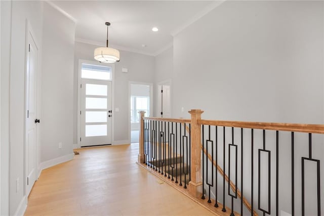 7050 NW Yulich Ct, Parkville, MO 64152 - hallway featuring light wood-style floors, crown molding, an upstairs landing, and a high ceiling