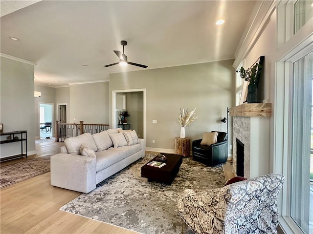 7050 NW Yulich Ct, Parkville, MO 64152 - living room featuring wood finished floors, ceiling fan, a fireplace, crown molding, and recessed lighting