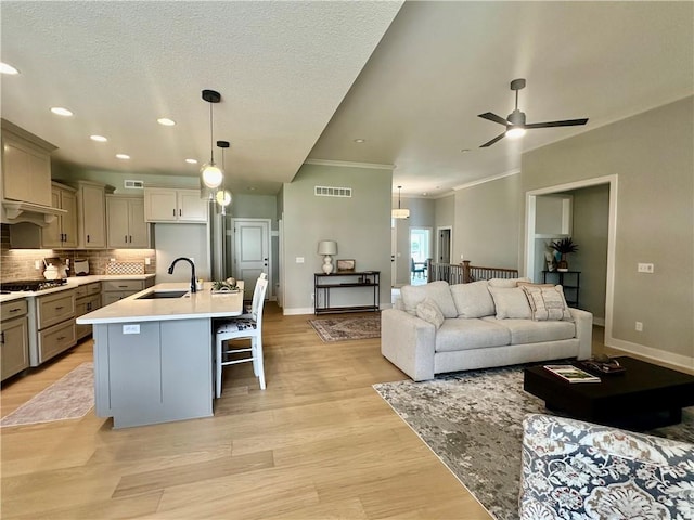 7050 NW Yulich Ct, Parkville, MO 64152 - living area with ceiling fan, crown molding, light wood finished floors, and recessed lighting