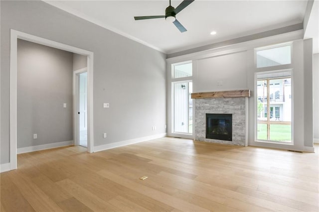 7050 NW Yulich Ct, Parkville, MO 64152 - unfurnished living room featuring plenty of natural light, light wood finished floors, a ceiling fan, crown molding, and recessed lighting