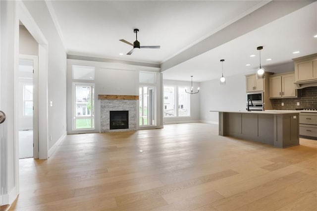 7050 NW Yulich Ct, Parkville, MO 64152 - kitchen featuring stainless steel appliances, ceiling fan, light wood-type flooring, light countertops, and ornamental molding