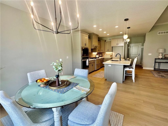 7050 NW Yulich Ct, Parkville, MO 64152 - dining area with a chandelier, light wood-style flooring, and recessed lighting