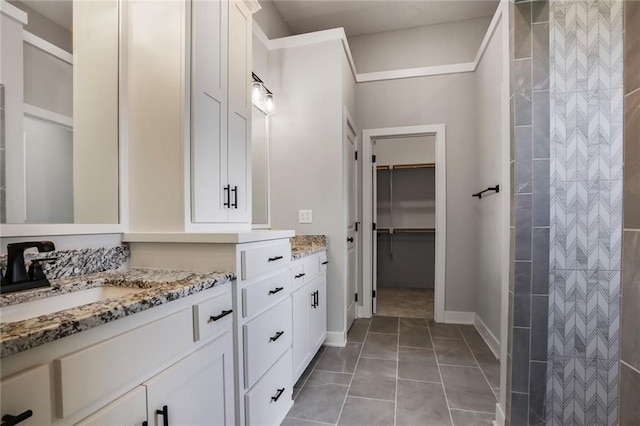 7050 NW Yulich Ct, Parkville, MO 64152 - bathroom featuring vanity, a walk in closet, a shower, and tile patterned floors