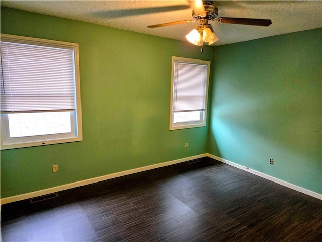 empty room featuring ceiling fan, a textured ceiling, and hardwood / wood-style flooring