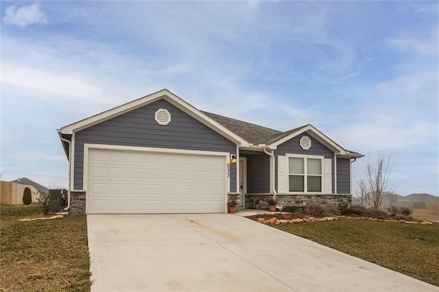 view of front facade with central AC, a front yard, and a garage