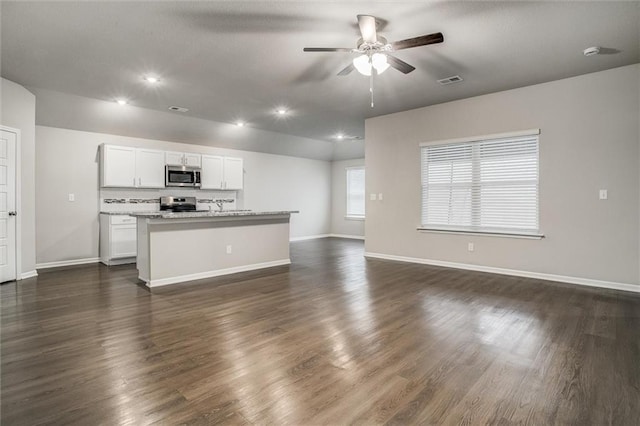 kitchen featuring a kitchen island with sink, white cabinets, dark hardwood / wood-style floors, and appliances with stainless steel finishes