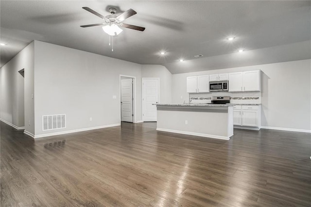 unfurnished living room featuring dark hardwood / wood-style flooring, ceiling fan, and lofted ceiling