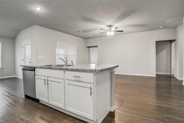 kitchen featuring a kitchen island with sink, white cabinets, sink, stainless steel dishwasher, and dark hardwood / wood-style floors