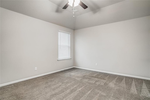 carpeted empty room with vaulted ceiling and ceiling fan