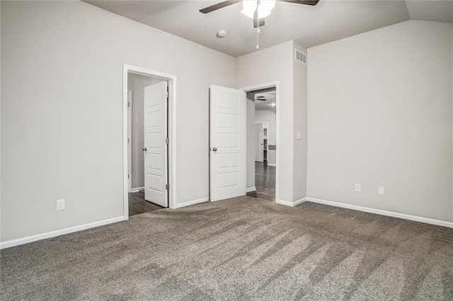 unfurnished bedroom with ceiling fan, dark carpet, and vaulted ceiling