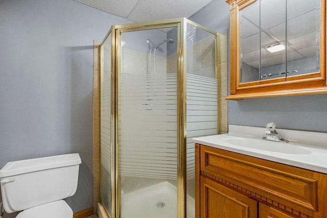 bathroom featuring an enclosed shower, vanity, and toilet