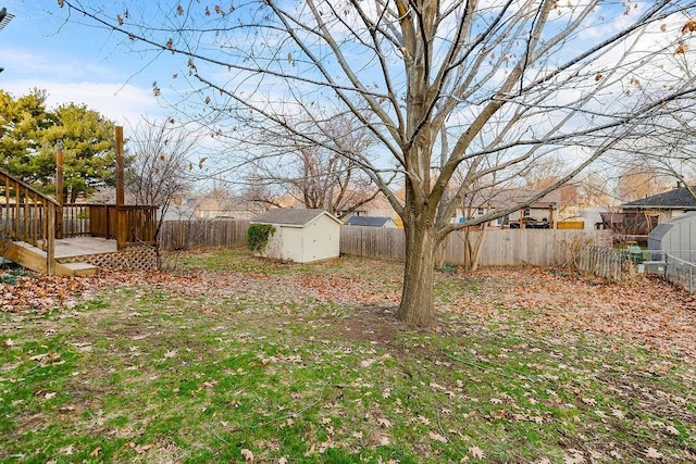 view of yard with a storage shed and a wooden deck