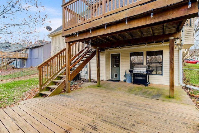 wooden terrace featuring a grill