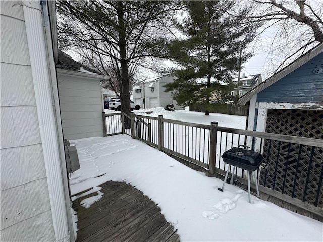 snow covered deck featuring a grill