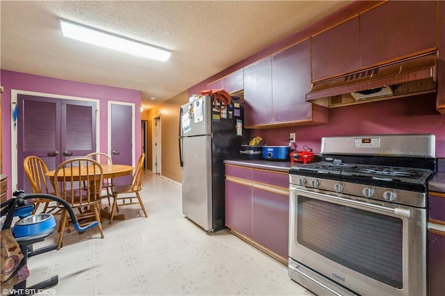 kitchen featuring a textured ceiling and stainless steel appliances