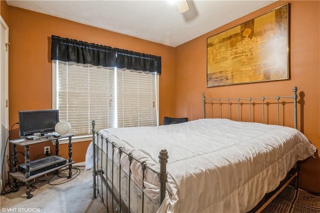 bedroom with ceiling fan and carpet