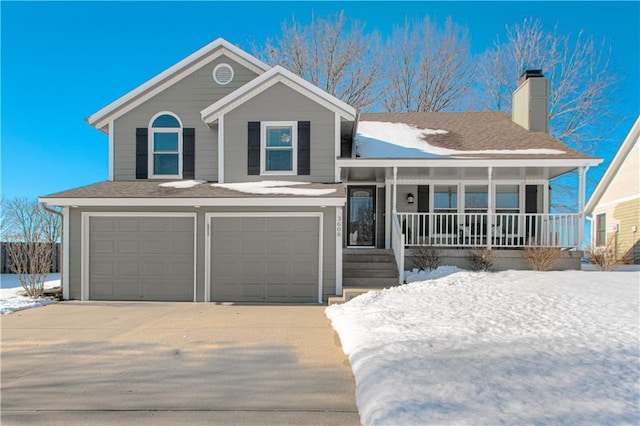 view of front of house featuring a garage and a porch