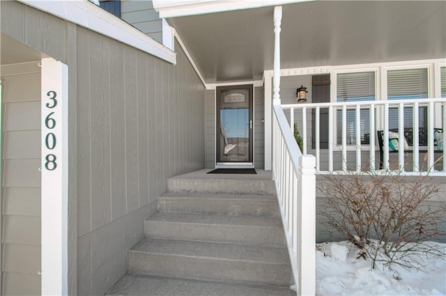 view of snow covered property entrance