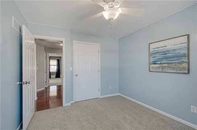 unfurnished bedroom with ceiling fan and carpet floors