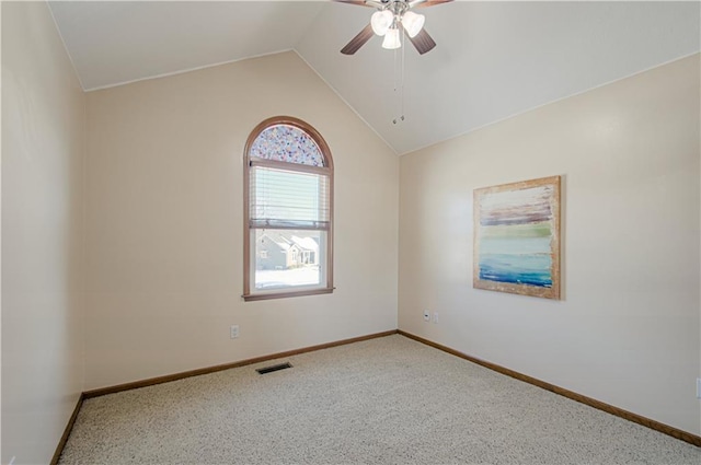 spare room featuring ceiling fan, carpet, and lofted ceiling