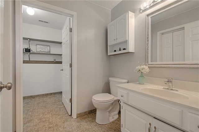 bathroom featuring toilet and vanity