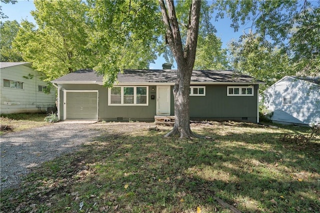 ranch-style house with a front yard and a garage