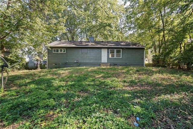 rear view of house with a yard