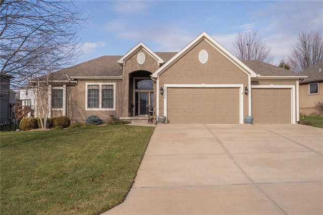 view of front of property with a front yard and a garage