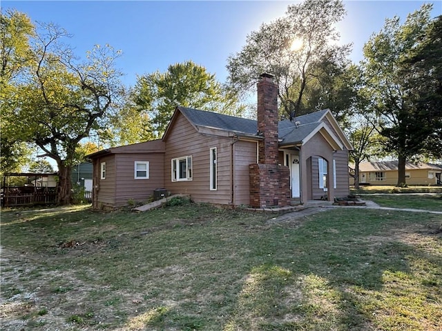 rear view of property with a lawn