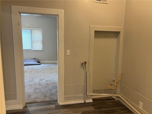 hallway with dark hardwood / wood-style floors