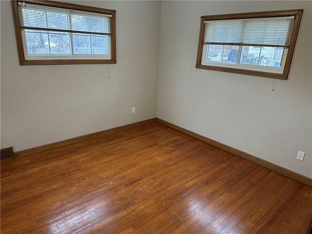 spare room with hardwood / wood-style flooring