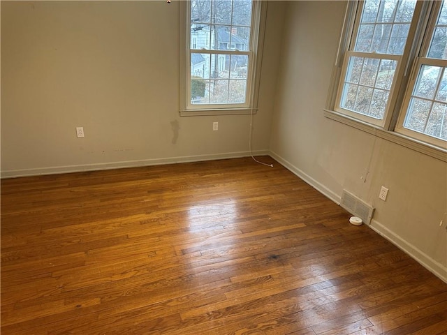 unfurnished room featuring dark hardwood / wood-style flooring