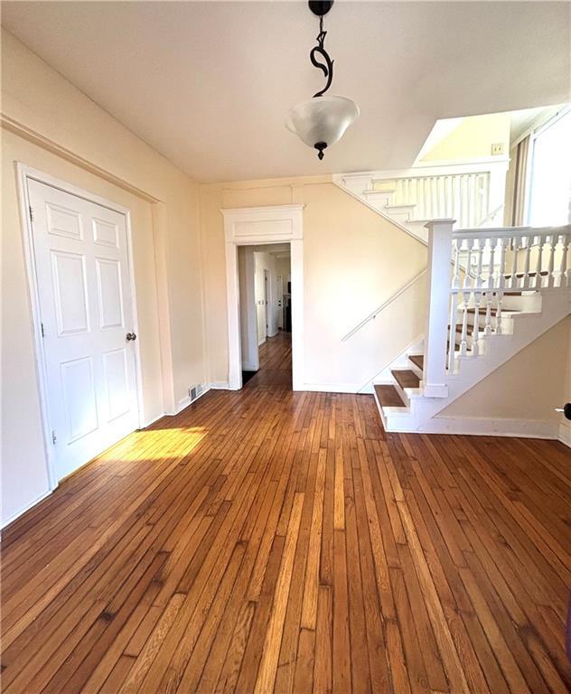 unfurnished living room with wood-type flooring