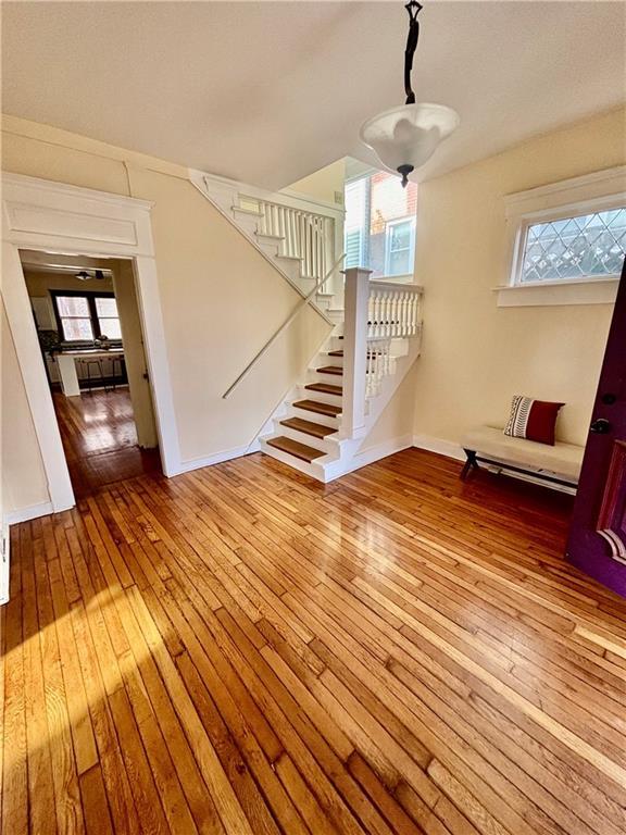 staircase with hardwood / wood-style floors