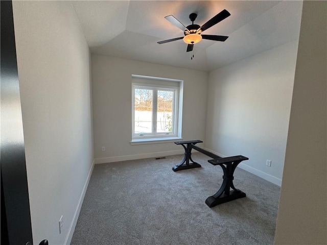 workout area featuring lofted ceiling, ceiling fan, and carpet flooring