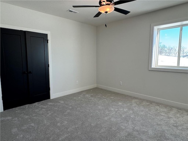 unfurnished bedroom with carpet floors, ceiling fan, and a closet