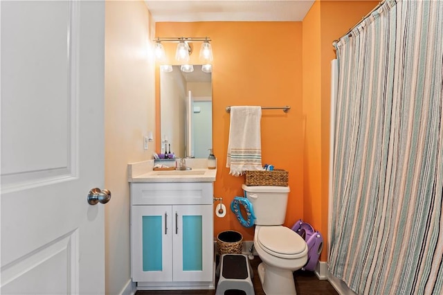 bathroom featuring walk in shower, vanity, and toilet