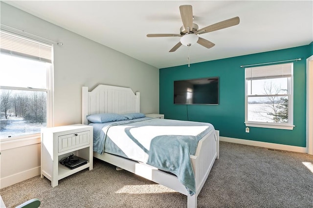 bedroom featuring multiple windows, carpet floors, and ceiling fan