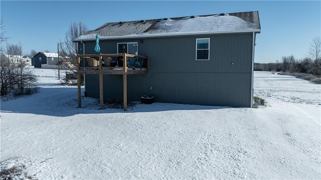 snow covered property featuring a deck