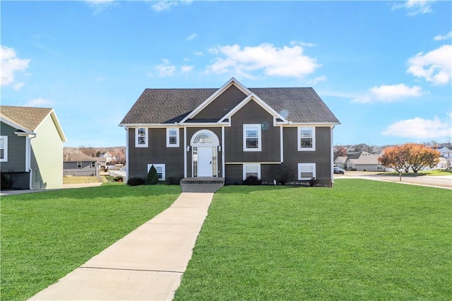 raised ranch with a front lawn