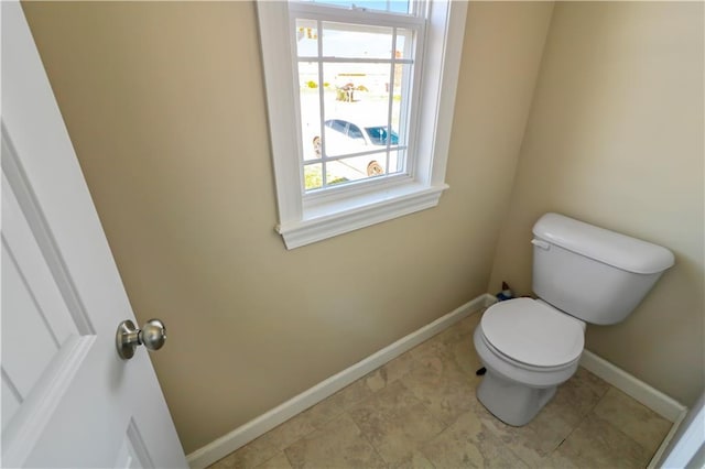 bathroom with toilet and a wealth of natural light