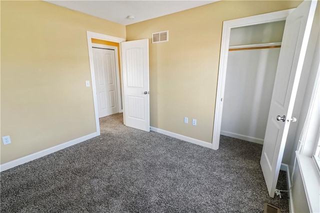 unfurnished bedroom with dark carpet