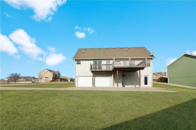 back of house featuring a garage, driveway, a lawn, and a wooden deck